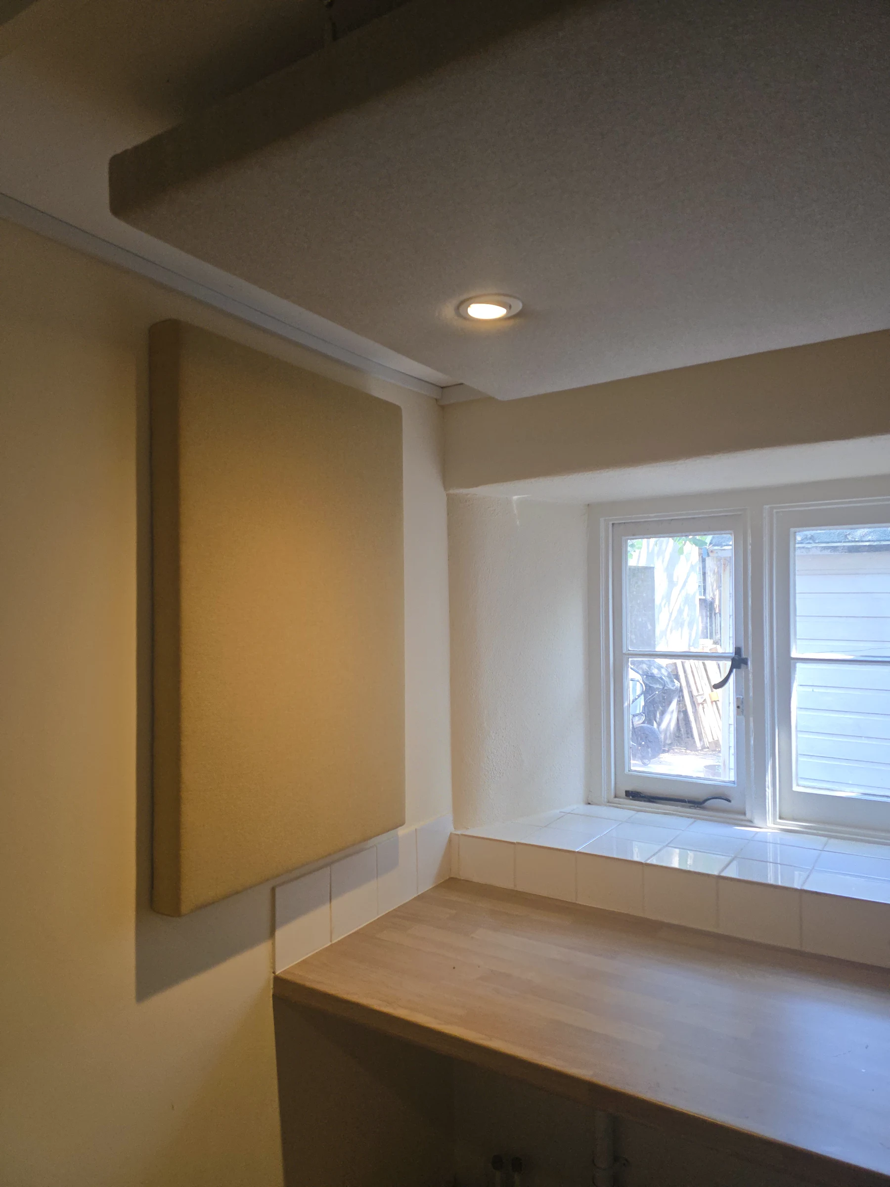 Wall and ceiling acoustic treatment beside the window