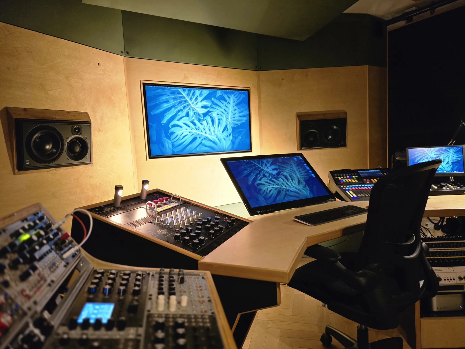 Close view of the Liminal Audio mastering desk and flush-mounted monitoring speakers